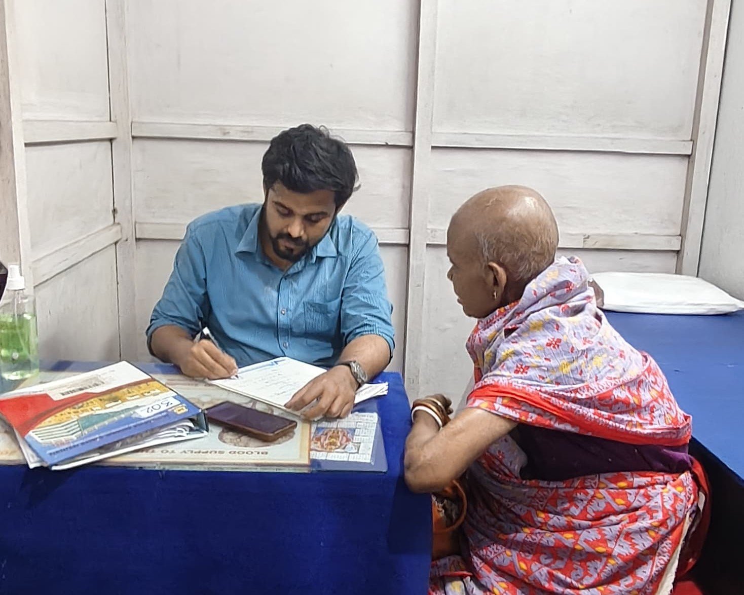 Dr. Arindam Acharyya examining a patient during chamber consultation in Kalyani